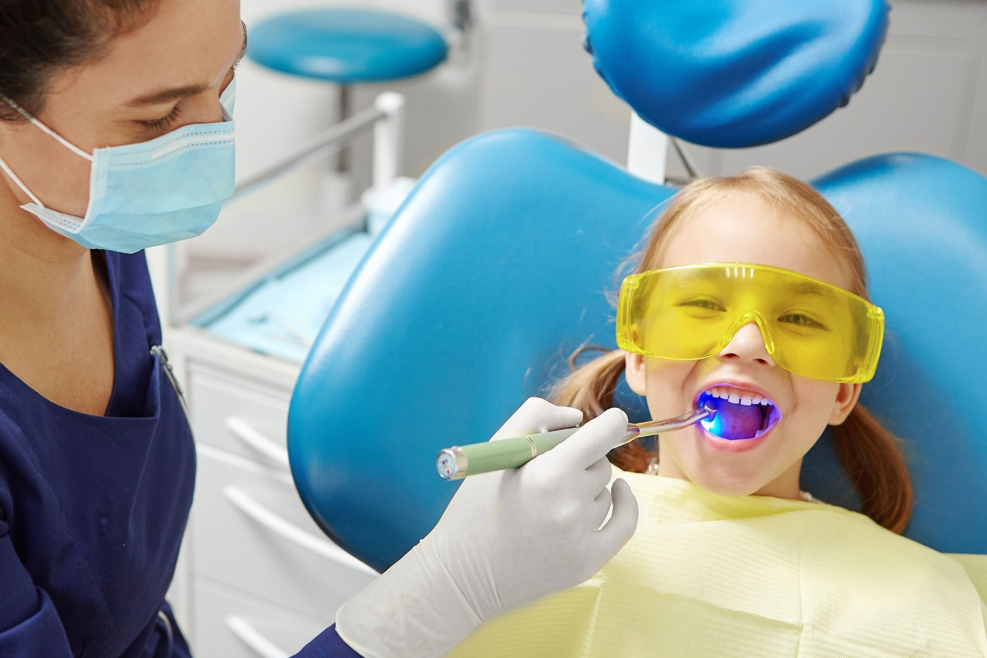 pediatric dentist examining a child