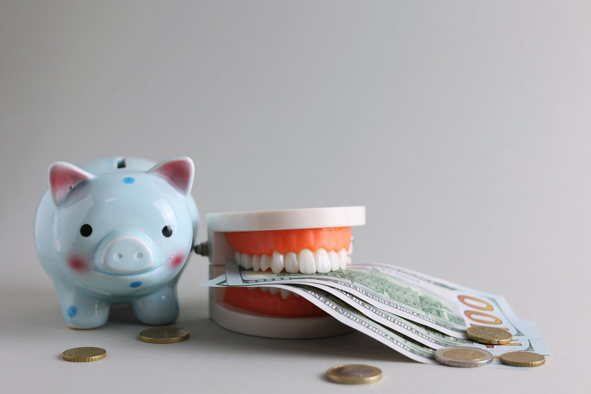 Dental model of teeth and money. The price of dental services. . High quality photo