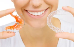 Beautiful smiling Girl Holding Retainer For Teeth Image Image