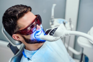 Dentist beginning a teeth whitening procedure with a patient
