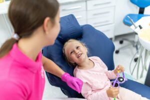Cheerful pediatric dentist with a smiling young patient at SmileWorks in Manhattan